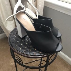 High heeled, buckled black and white fun shoes.